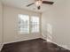 Well-lit bedroom featuring two windows and dark floors at 152 Oliver St, York, SC 29745