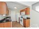 Efficient galley kitchen, featuring wood cabinets and granite countertops at 152 Oliver St, York, SC 29745