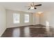 Bright living room with dark hardwood floors and ceiling fan at 152 Oliver St, York, SC 29745