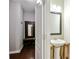 Hall bathroom featuring a modern pedestal sink, mirror, tile flooring, and a view into the hallway at 162 Misty Woods Dr, Lake Wylie, SC 29710