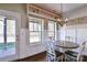 Bright dining area with a round table, white wainscoting, transom windows, and a view to the fenced backyard at 162 Misty Woods Dr, Lake Wylie, SC 29710