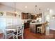 Open concept kitchen with stainless steel appliances, dark wood cabinets, and granite countertops at 162 Misty Woods Dr, Lake Wylie, SC 29710