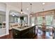 Open kitchen featuring dark cabinetry, stainless steel appliances, a breakfast bar, and hardwood flooring, with a view into the living room at 162 Misty Woods Dr, Lake Wylie, SC 29710