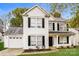 Two-story house with white siding, black shutters, and a two-car garage at 1655 Baylor Dr, Rock Hill, SC 29732