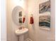 Stylish powder room with a pedestal sink and framed artwork at 170 Swann Rd, Statesville, NC 28265