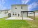 Home's rear elevation, featuring a pergola-covered patio and grassy area at 1721 Ameria Rd, Charlotte, NC 28215