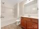 Bathroom with a shower/tub combo, wooden vanity, and wood-look flooring at 1721 Ameria Rd, Charlotte, NC 28215