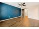 Main bedroom with barn door and blue accent wall at 1721 Ameria Rd, Charlotte, NC 28215