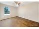 Simple bedroom with wood flooring and a large window at 1721 Ameria Rd, Charlotte, NC 28215