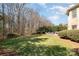 Expansive backyard featuring manicured lawn, mature trees, lush landscaping, and an outdoor firepit area for entertaining at 1806 Grayscroft Dr, Waxhaw, NC 28173