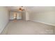 Spacious basement with neutral walls, ceiling fan, and carpeted floor, offering ample flexible space at 1806 Grayscroft Dr, Waxhaw, NC 28173