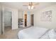 Bright bedroom with ceiling fan, art, and an open closet adjacent to the ensuite bath at 1806 Grayscroft Dr, Waxhaw, NC 28173