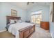 Bedroom features wood furniture, a ceiling fan, and a large window offering a view of the outdoors at 1806 Grayscroft Dr, Waxhaw, NC 28173