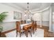 Elegant dining room with wood flooring, decorative molding, and ample natural light at 1806 Grayscroft Dr, Waxhaw, NC 28173