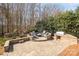 Outdoor living space with a brick firepit area and built-in grill at 1806 Grayscroft Dr, Waxhaw, NC 28173