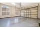 Clean garage with epoxy flooring, window for natural light, and ample storage space at 1806 Grayscroft Dr, Waxhaw, NC 28173