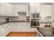 Stylish kitchen featuring white cabinets, granite countertops, and stainless steel appliances at 1806 Grayscroft Dr, Waxhaw, NC 28173