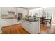 Modern kitchen with white cabinetry, stainless steel appliances, and hardwood floors at 1806 Grayscroft Dr, Waxhaw, NC 28173