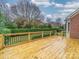 A newly stained wood back deck surrounded by lush landscaping and wrought iron railing at 209 Chesterfield Canal None, Fort Mill, SC 29708