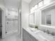 Stylish bathroom featuring a double vanity, mirrors, and tiled shower at 209 Chesterfield Canal None, Fort Mill, SC 29708