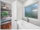 Luxurious soaking tub next to frosted window with bedroom visible in background at 209 Chesterfield Canal None, Fort Mill, SC 29708