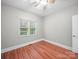 Bright bedroom features hardwood floors, a large window, and a ceiling fan at 209 Chesterfield Canal None, Fort Mill, SC 29708