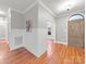 Inviting entryway featuring wood floors, wainscoting, and an arched doorway providing character and charm at 209 Chesterfield Canal None, Fort Mill, SC 29708