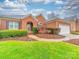 Charming brick home featuring mature landscaping, inviting entryway, and attached two car garage at 209 Chesterfield Canal None, Fort Mill, SC 29708