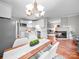 Bright living room with a modern chandelier, fireplace, and open concept kitchen, creating a cozy and inviting space at 209 Chesterfield Canal None, Fort Mill, SC 29708