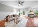 Cozy living room with hardwood floors, fireplace, ceiling fan, and sliding doors to outdoor deck at 209 Chesterfield Canal None, Fort Mill, SC 29708