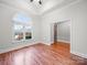 Bright living room with large arched window, hardwood floors, ceiling fan, and neutral paint tones at 209 Chesterfield Canal None, Fort Mill, SC 29708