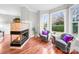 Bright sunroom featuring corner fireplace, hardwood floors, bay windows and comfortable seating at 209 Chesterfield Canal None, Fort Mill, SC 29708