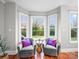 Bright sunroom showcasing hardwood floors, bay windows, and comfortable armchairs with accent pillows at 209 Chesterfield Canal None, Fort Mill, SC 29708