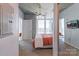 Bedroom with carpet, orange accents, ceiling fan, and a view of the city skyline at 210 N Church St # 2411, Charlotte, NC 28202