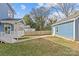 View of the backyard, porch, shed, and grass lawn at 2100 St Paul St, Charlotte, NC 28216