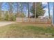 Fenced backyard with a grass lawn and bare trees during the winter season at 2100 St Paul St, Charlotte, NC 28216