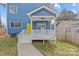 Charming blue house with a inviting white porch and a bright yellow front door at 2100 St Paul St, Charlotte, NC 28216