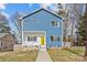 Charming two-story home with blue siding, white trim, and a bright yellow front door at 2100 St Paul St, Charlotte, NC 28216