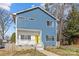 Charming two-story home with blue siding, white trim, and a bright yellow front door at 2100 St Paul St, Charlotte, NC 28216