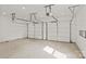 A spacious two car garage interior features white doors and a concrete floor at 2100 St Paul St, Charlotte, NC 28216