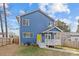 View of the back of the house with covered porch and fenced backyard at 2100 St Paul St, Charlotte, NC 28216