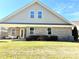 Home's rear elevation showcases brick and siding at 21087 Cadence Trace Dr, Mint Hill, NC 28227