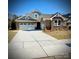 Brick home with three-car garage and landscaped front yard at 21087 Cadence Trace Dr, Mint Hill, NC 28227