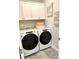 Laundry room with Whirlpool washer and dryer, and white cabinets at 21087 Cadence Trace Dr, Mint Hill, NC 28227