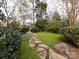 Landscaped backyard with stone pathway and lush greenery at 2121 Winter St, Charlotte, NC 28205