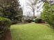 Landscaped backyard with a lush lawn and stone pathway at 2121 Winter St, Charlotte, NC 28205