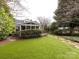 Spacious backyard with screened porch, stone path, and lush landscaping at 2121 Winter St, Charlotte, NC 28205