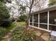 Landscaped backyard with flagstone pathways, lush greenery, and a screened porch at 2121 Winter St, Charlotte, NC 28205