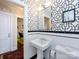 Clean bathroom with pedestal sink, black and white geometric wallpaper and white subway tile at 2121 Winter St, Charlotte, NC 28205