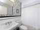 Stylish bathroom with black and white geometric wallpaper and subway tile at 2121 Winter St, Charlotte, NC 28205